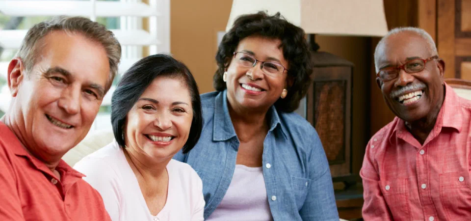 A group of smiling older adults outdoors