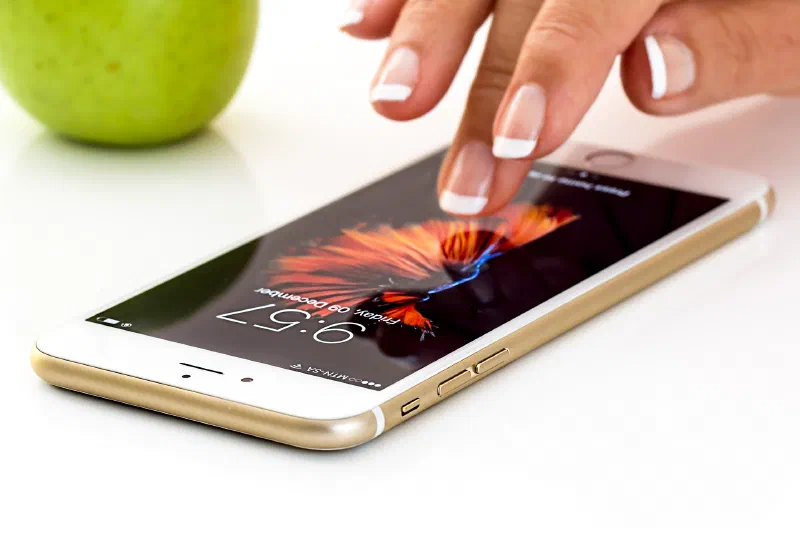 Lady touching iPhone screen