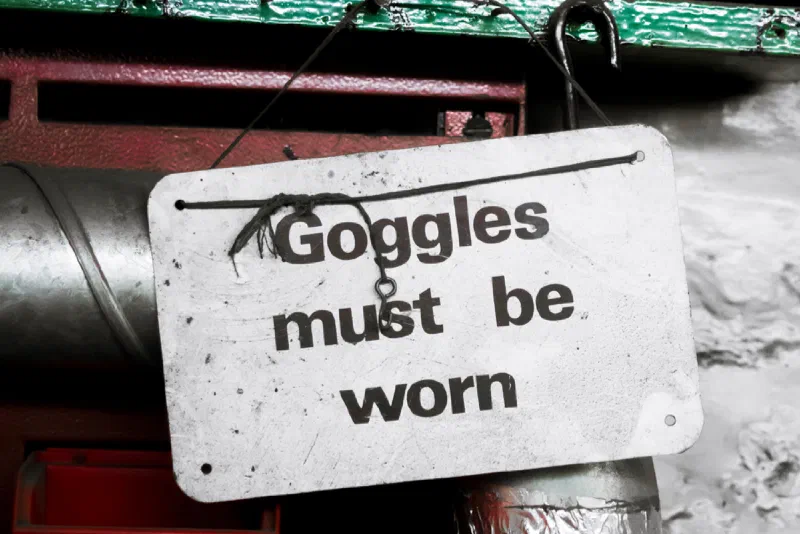 Picture of a sign that reads, "Goggles must be worn."